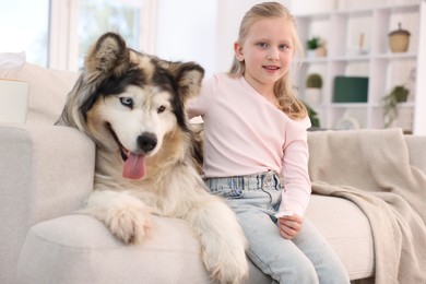Photo of Girl suffering from allergy with her dog at home