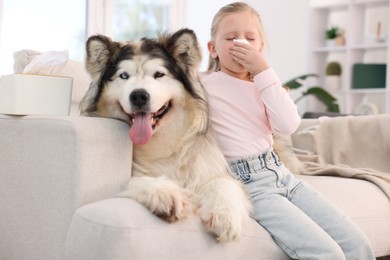 Photo of Girl suffering from allergy with her dog at home