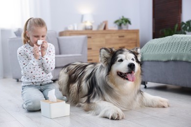 Photo of Girl suffering from allergy with her dog at home