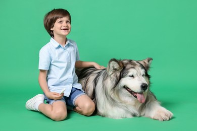Photo of Happy boy and cute dog on green background