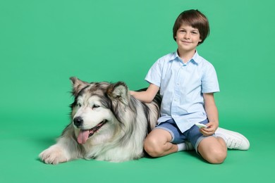 Photo of Happy boy and cute dog on green background