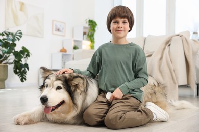 Photo of Happy boy and cute dog at home