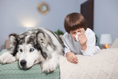Photo of Boy suffering from allergy with her dog on bed at home