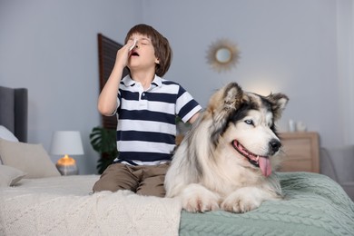 Photo of Boy suffering from allergy with her dog on bed at home