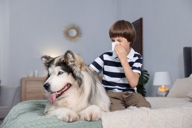 Photo of Boy suffering from allergy with her dog on bed at home