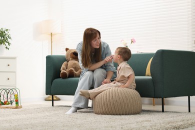 Photo of Happy mother spending time together with her son at home
