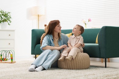 Photo of Happy mother spending time together with her son at home