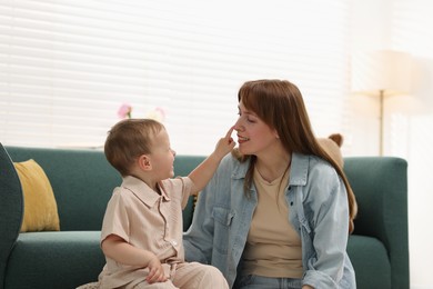Photo of Happy mother spending time together with her son at home