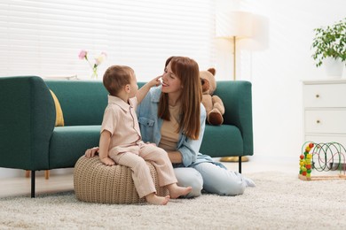Photo of Happy mother spending time together with her son at home