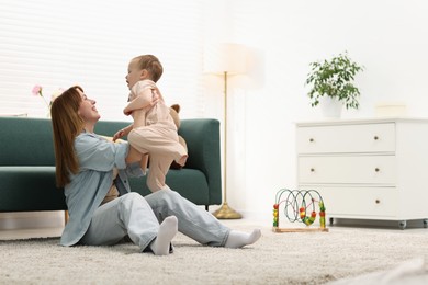 Photo of Happy mother spending time together with her son on floor at home
