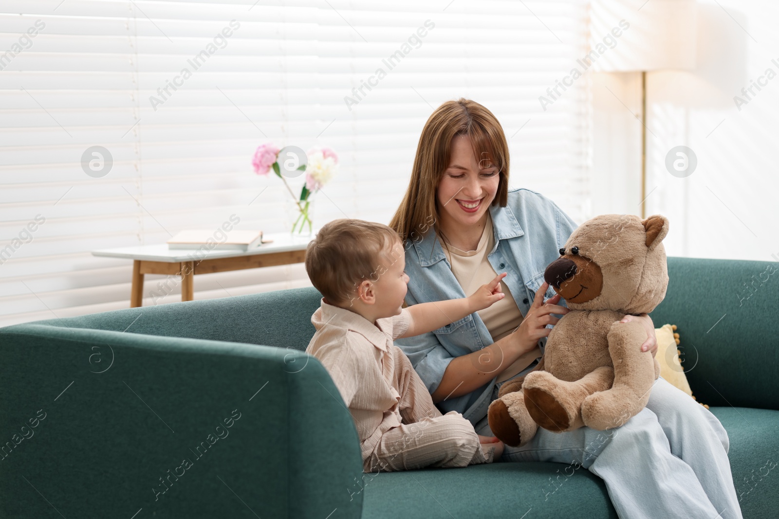 Happy mother with her son on sofa at home Photo of Happy mother with her son on sofa at home