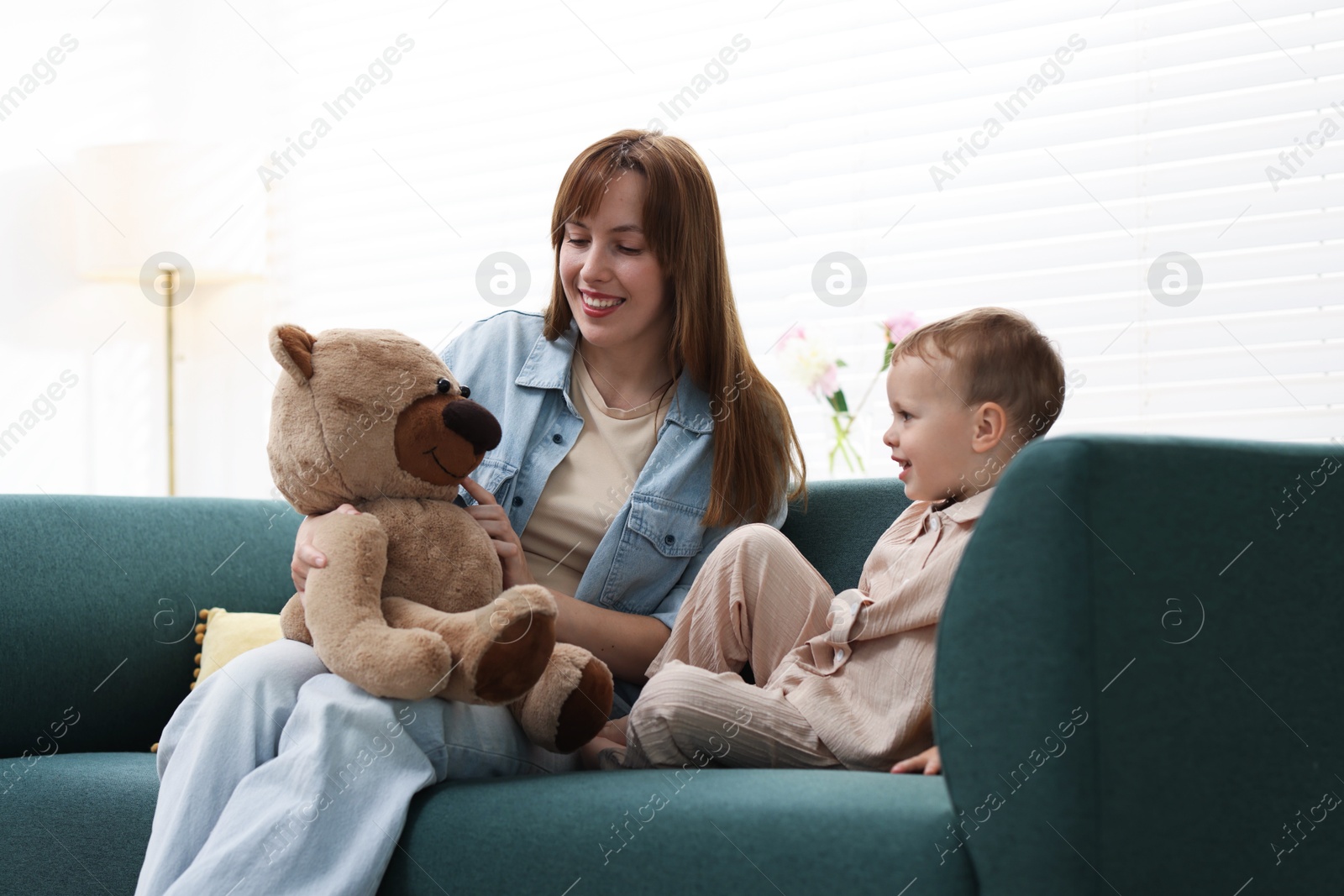 Happy mother with her son on sofa at home Photo of Happy mother with her son on sofa at home