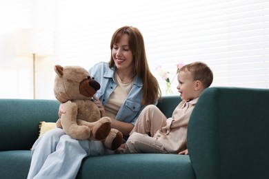 Photo of Happy mother with her son on sofa at home