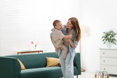 Photo of Happy mother spending time together with her son at home
