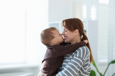 Photo of Happy mother spending time together with her son at home