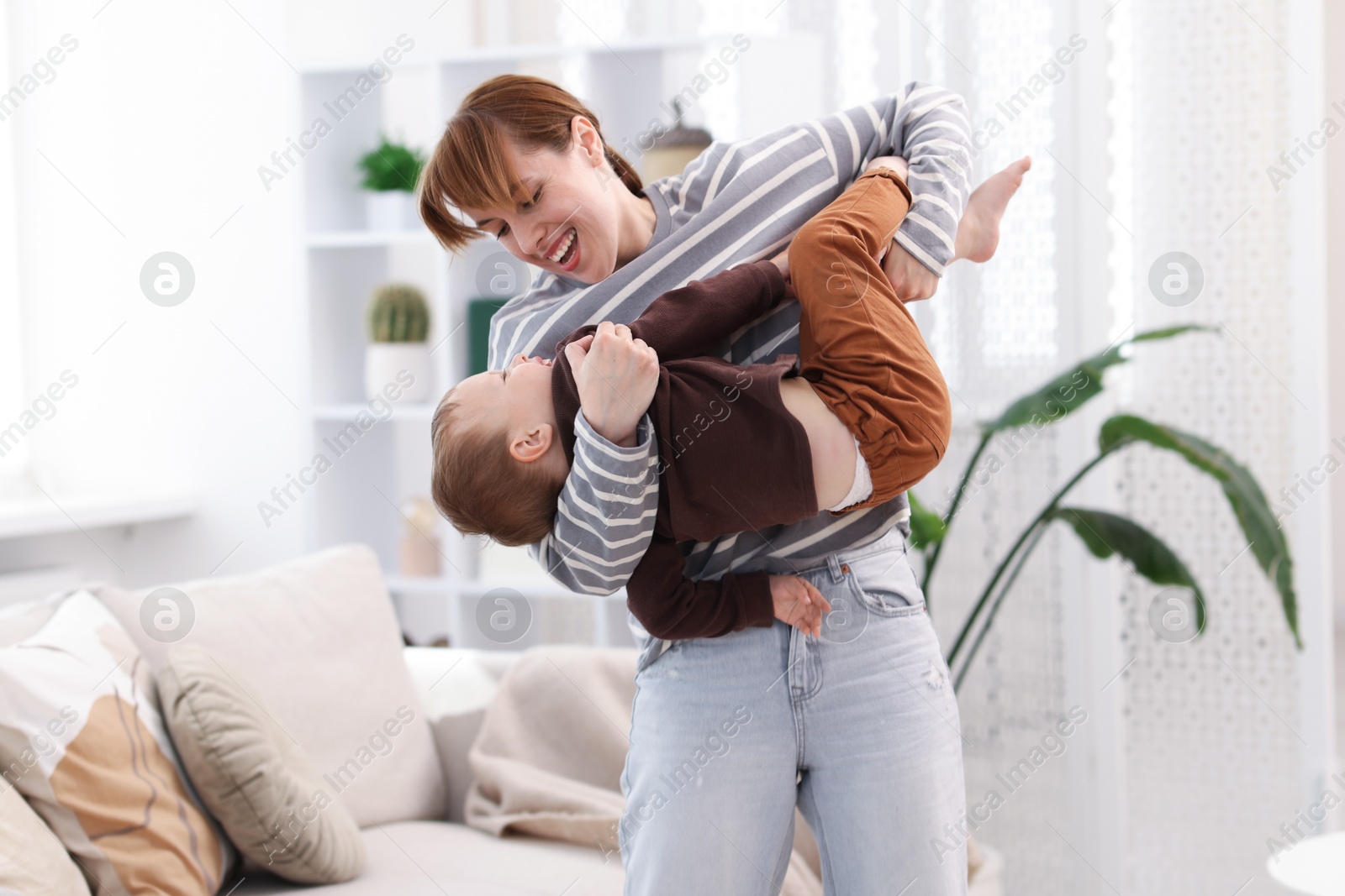 Happy mother playing with her son at home Photo of Happy mother playing with her son at home