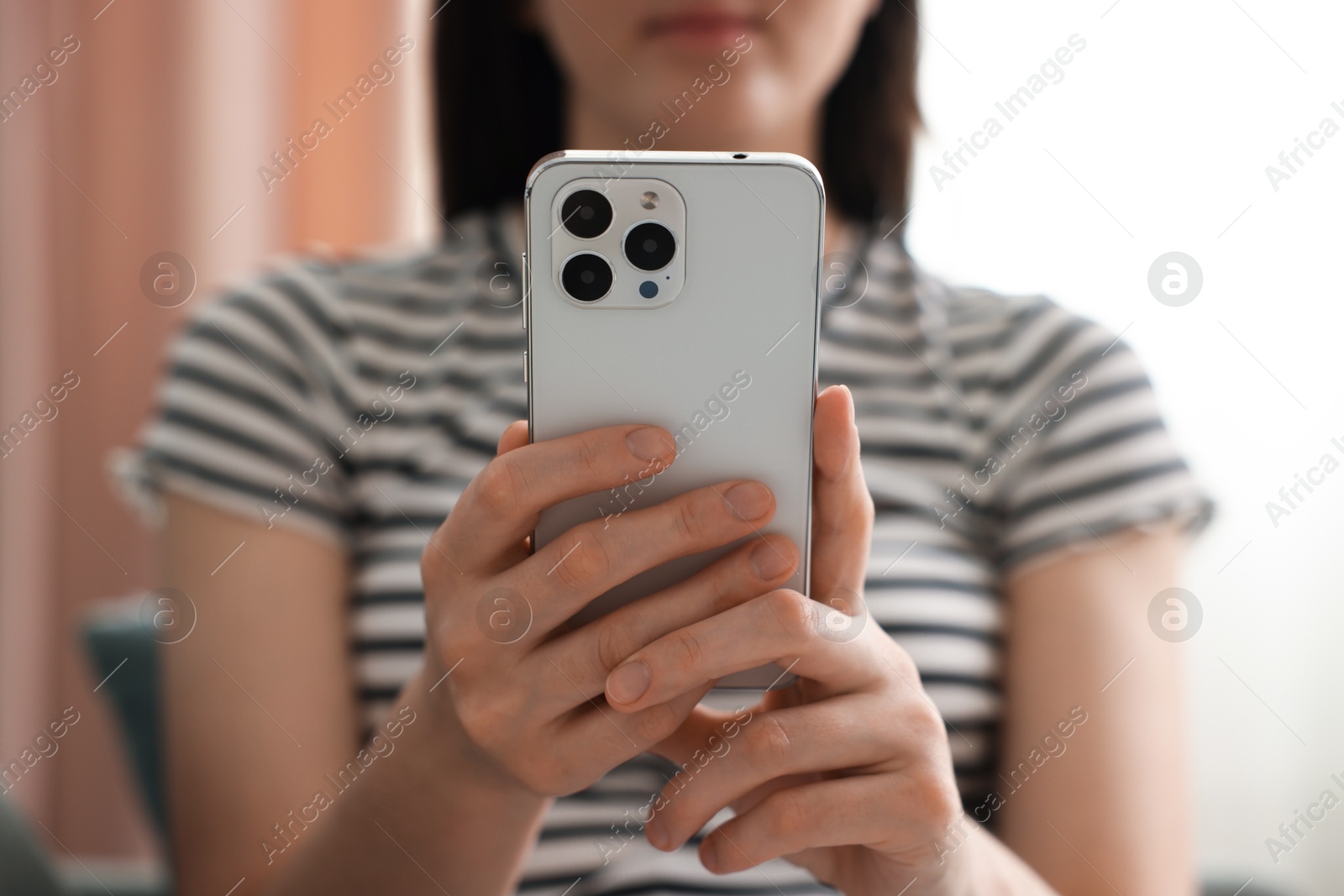 Woman using modern smartphone at home, closeup Photo of Woman using modern smartphone at home, closeup