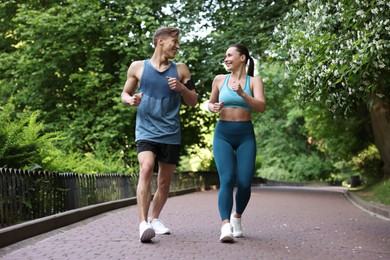 Photo of Sporty couple running in park. Healthy lifestyle