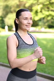 Photo of Sporty woman running in park. Healthy lifestyle