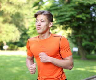 Photo of Sporty man running in park. Healthy lifestyle