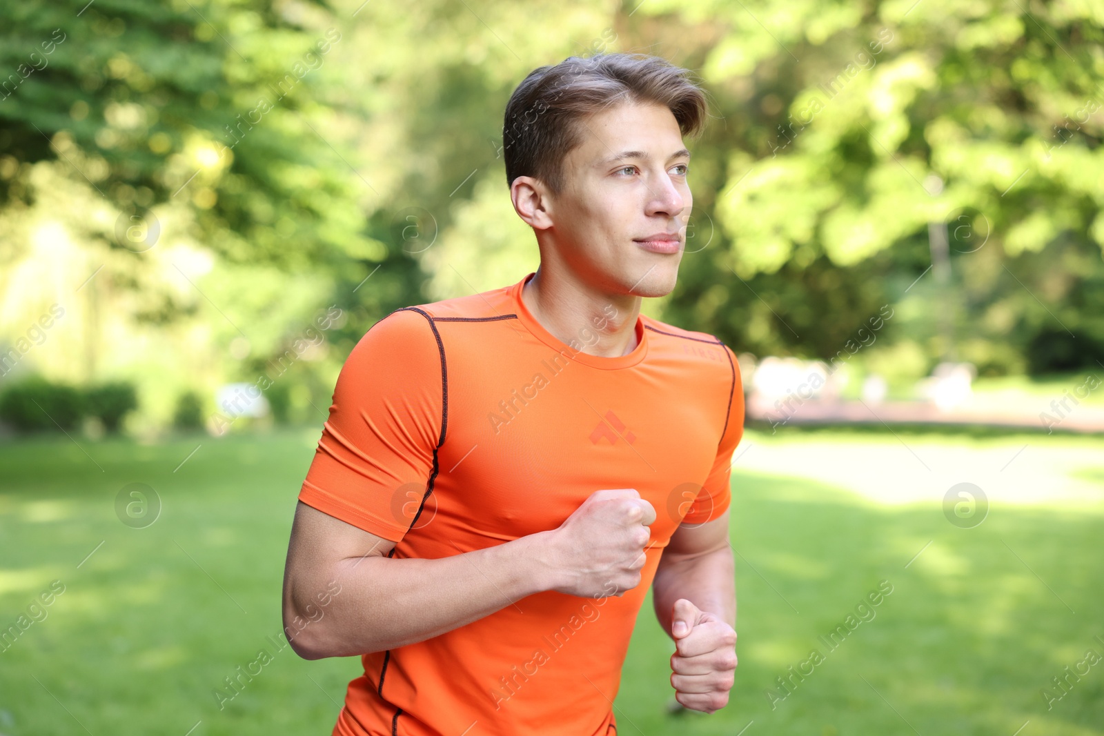 Sporty man running in park. Healthy lifestyle Photo of Sporty man running in park. Healthy lifestyle