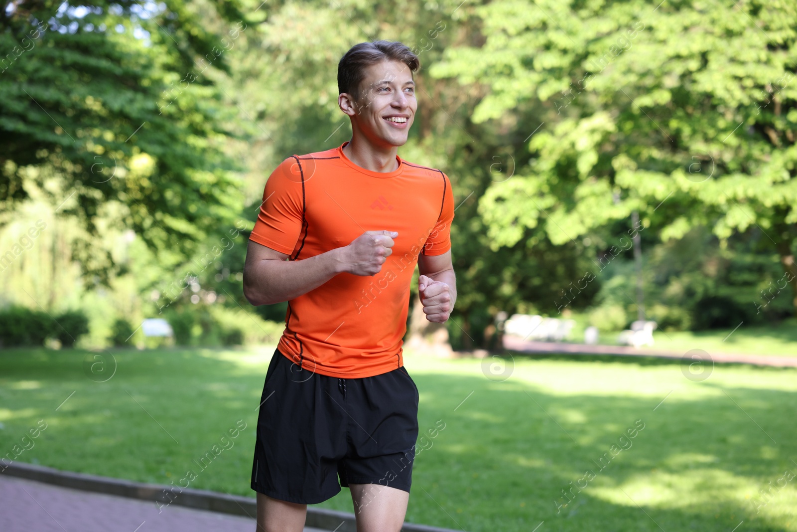 Sporty man running in park. Healthy lifestyle Photo of Sporty man running in park. Healthy lifestyle