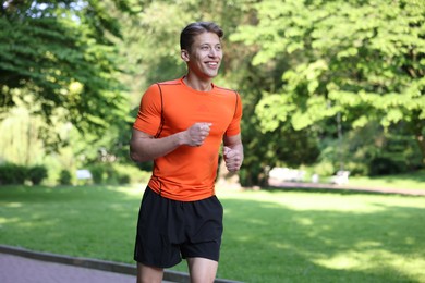 Photo of Sporty man running in park. Healthy lifestyle