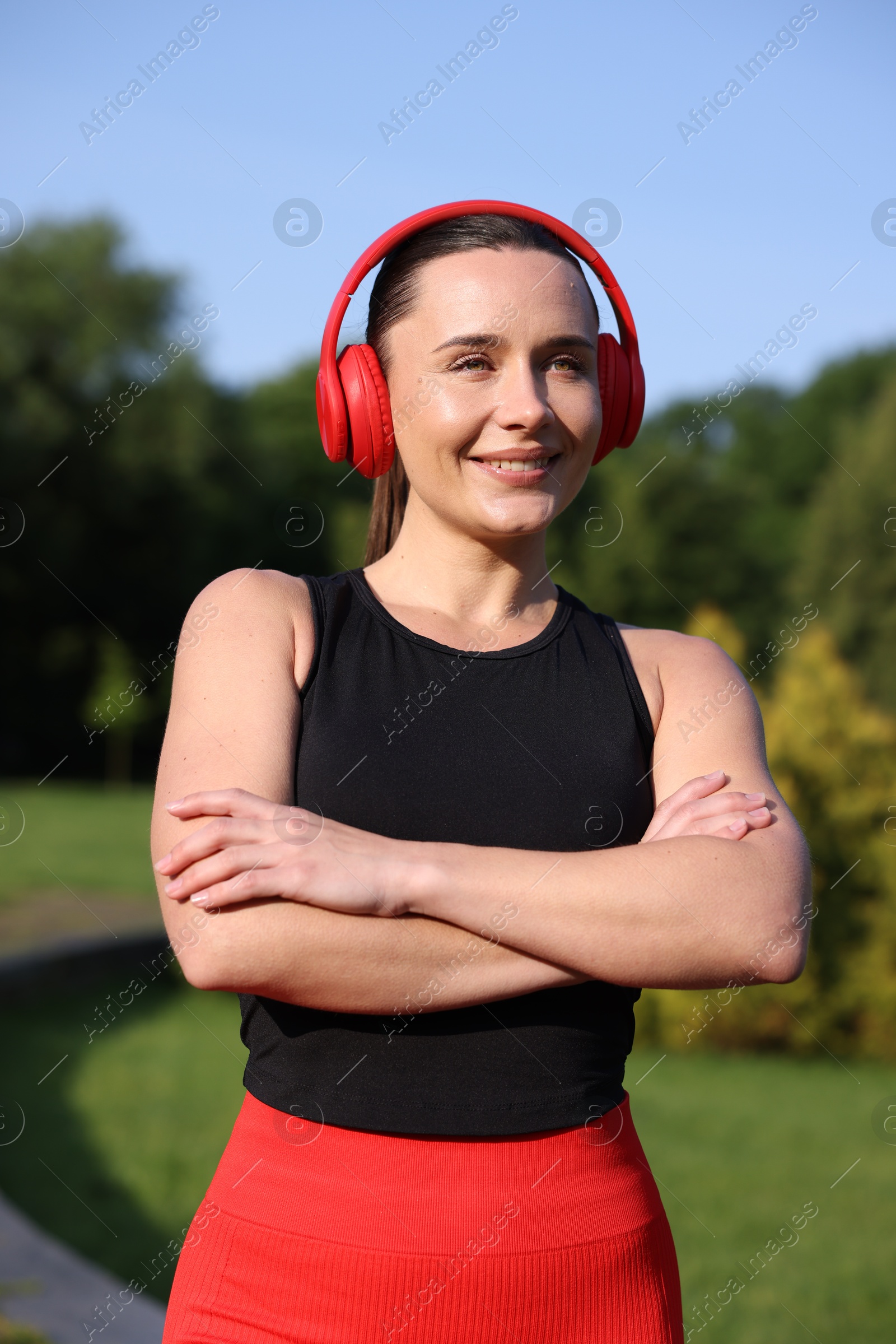 Happy woman in headphones outdoors. Healthy lifestyle Photo of Happy woman in headphones outdoors. Healthy lifestyle
