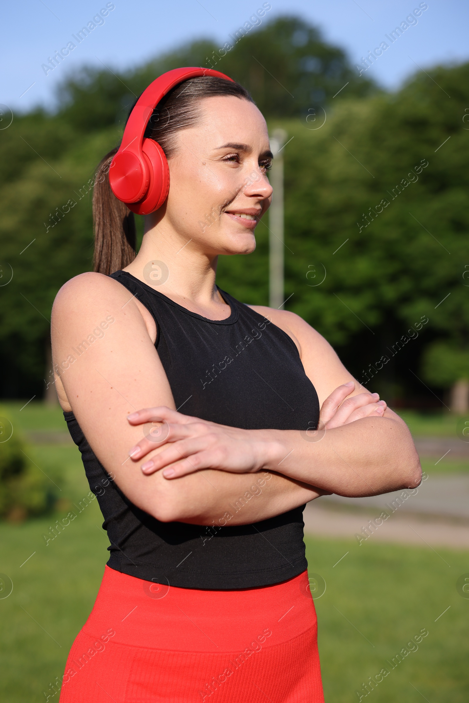 Happy woman in headphones outdoors. Healthy lifestyle Photo of Happy woman in headphones outdoors. Healthy lifestyle