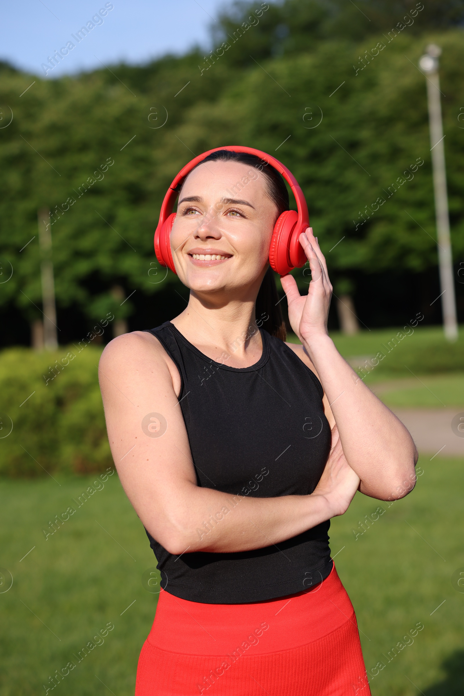 Happy woman in headphones outdoors. Healthy lifestyle Photo of Happy woman in headphones outdoors. Healthy lifestyle