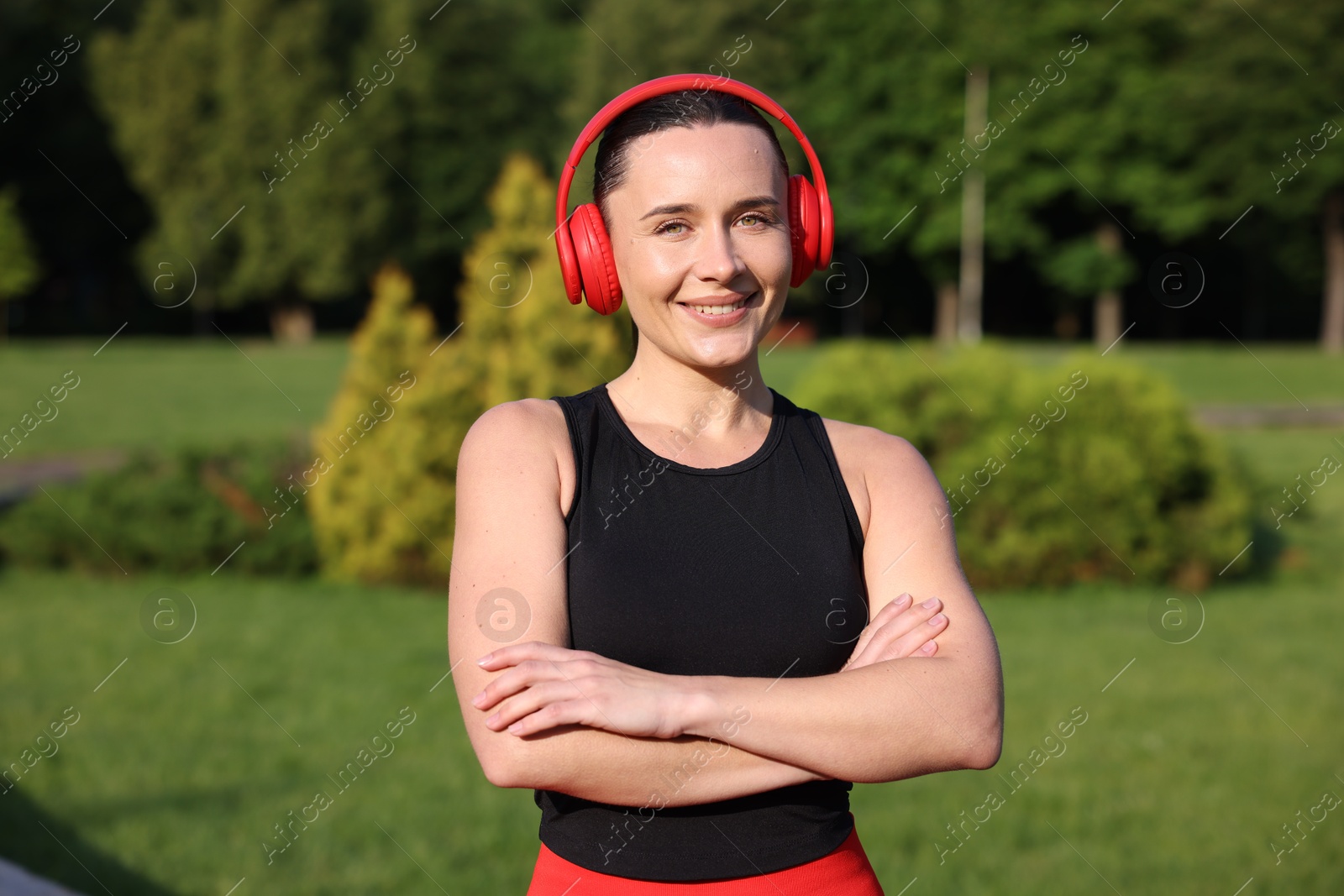 Happy woman in headphones outdoors. Healthy lifestyle Photo of Happy woman in headphones outdoors. Healthy lifestyle