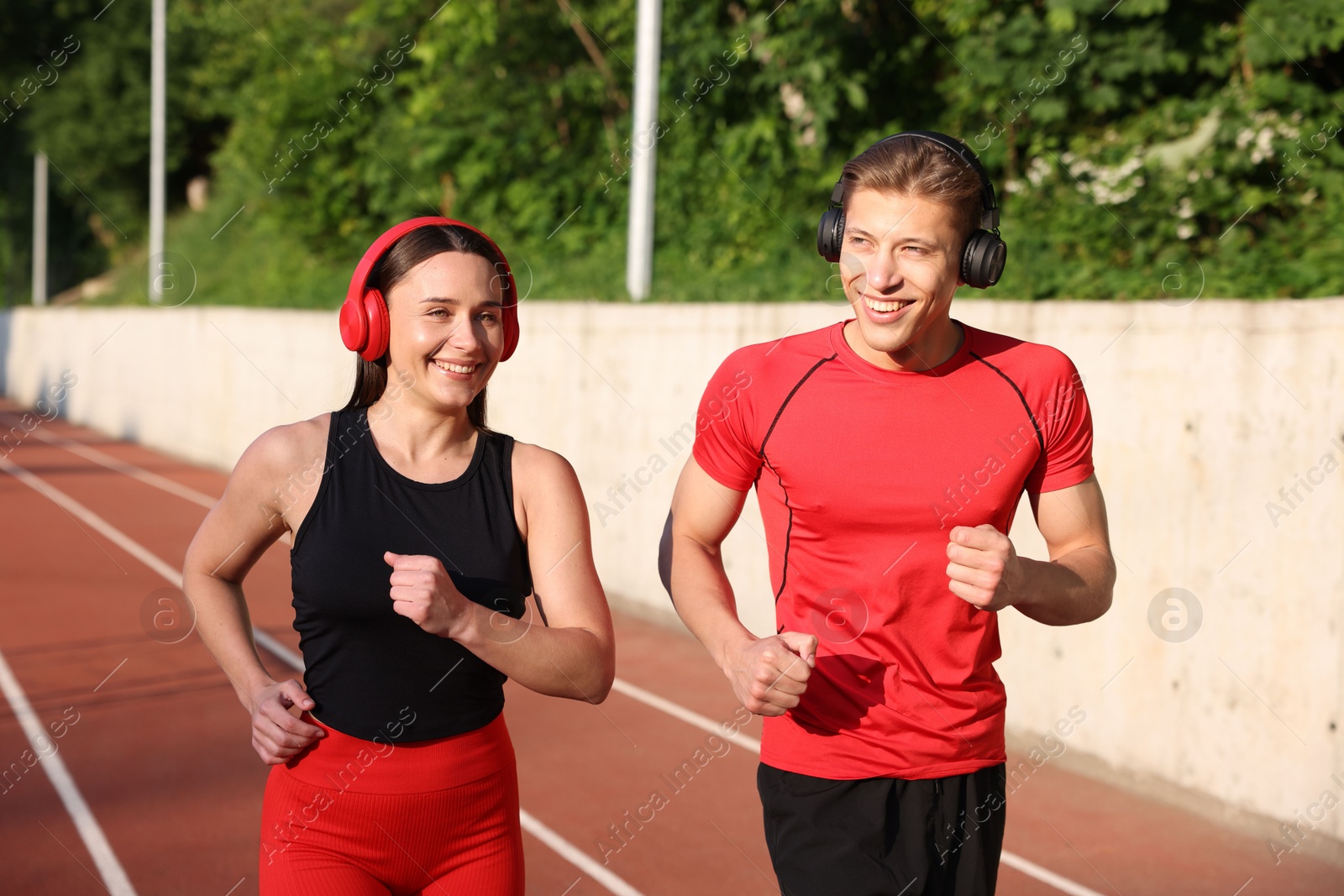 Sporty couple running at stadium. Healthy lifestyle Photo of Sporty couple running at stadium. Healthy lifestyle