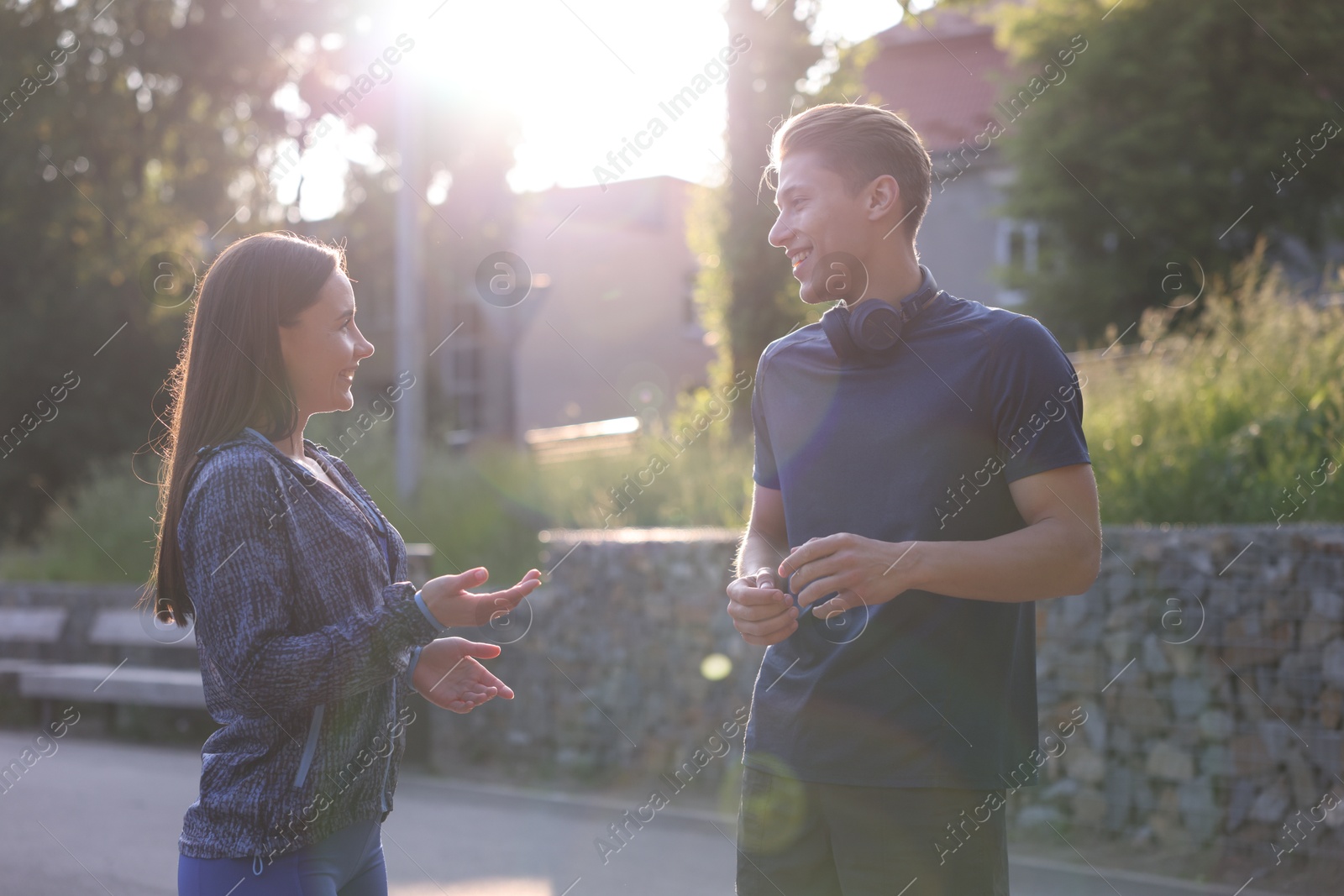 Couple in sportswear outdoors on sunny day. Healthy lifestyle Photo of Couple in sportswear outdoors on sunny day. Healthy lifestyle