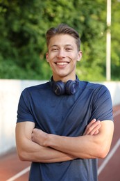 Photo of Portrait of sportsman with headphones at stadium