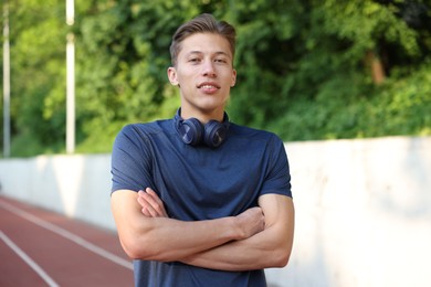 Photo of Portrait of sportsman with headphones at stadium