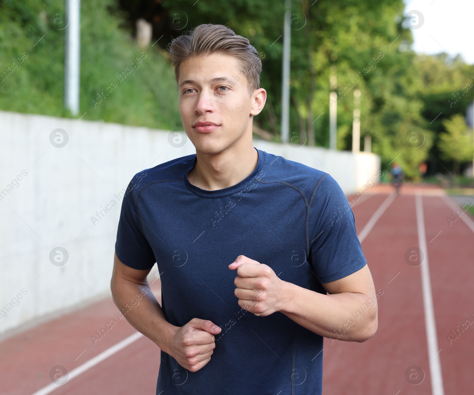 Sporty man running at stadium. Healthy lifestyle Photo of Sporty man running at stadium. Healthy lifestyle