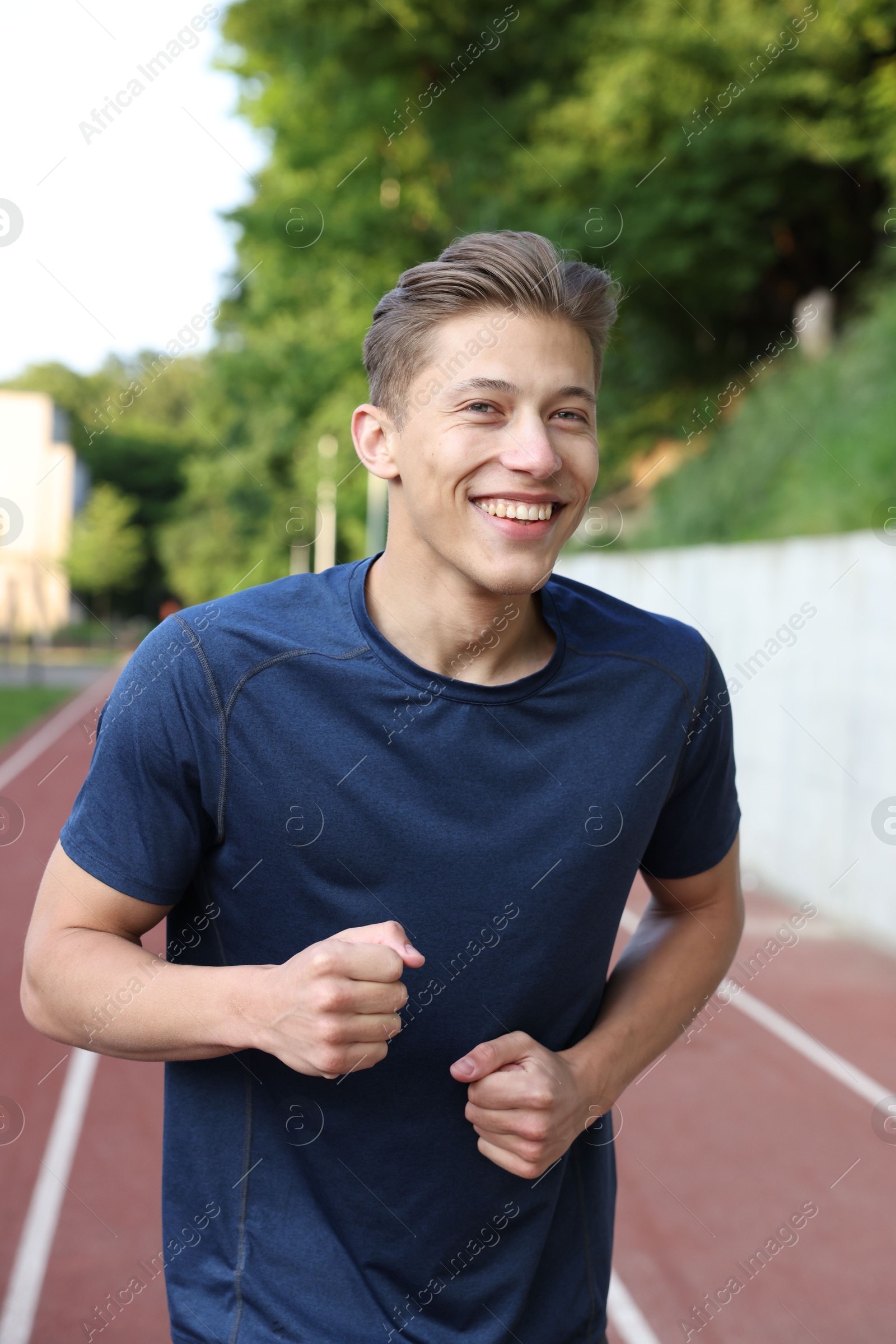 Sporty man running at stadium. Healthy lifestyle Photo of Sporty man running at stadium. Healthy lifestyle