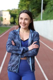 Photo of Happy woman in sportswear at stadium. Healthy lifestyle