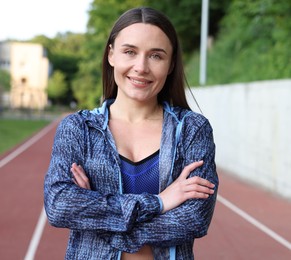 Photo of Happy woman in sportswear at stadium. Healthy lifestyle
