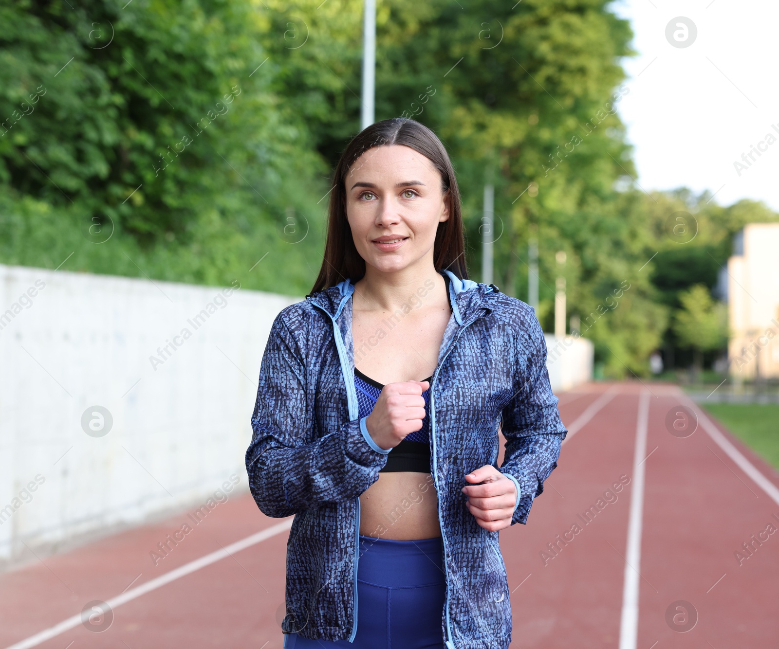 Sporty woman running at stadium. Healthy lifestyle Photo of Sporty woman running at stadium. Healthy lifestyle