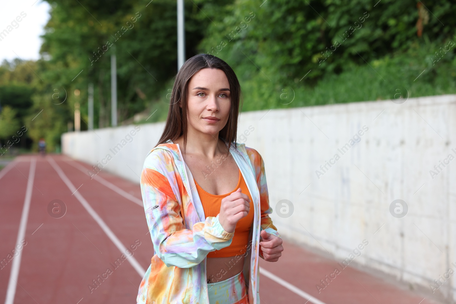 Sporty woman running at stadium. Healthy lifestyle Photo of Sporty woman running at stadium. Healthy lifestyle