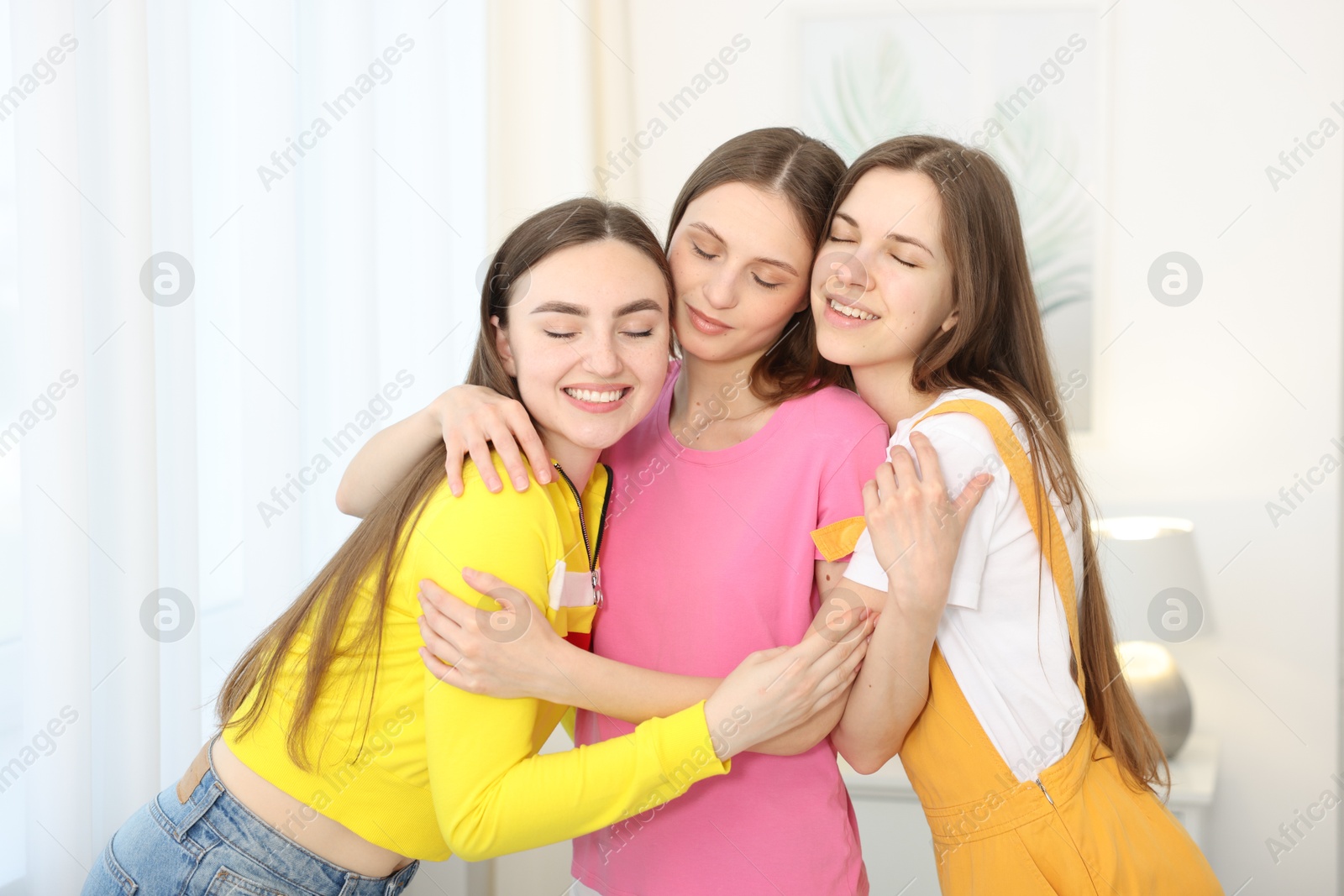 Happy friends hugging each other at home Photo of Happy friends hugging each other at home