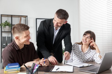Photo of Couple having meeting with business consultant at table in office