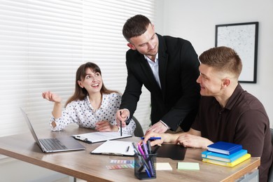 Photo of Couple having meeting with business consultant at table in office