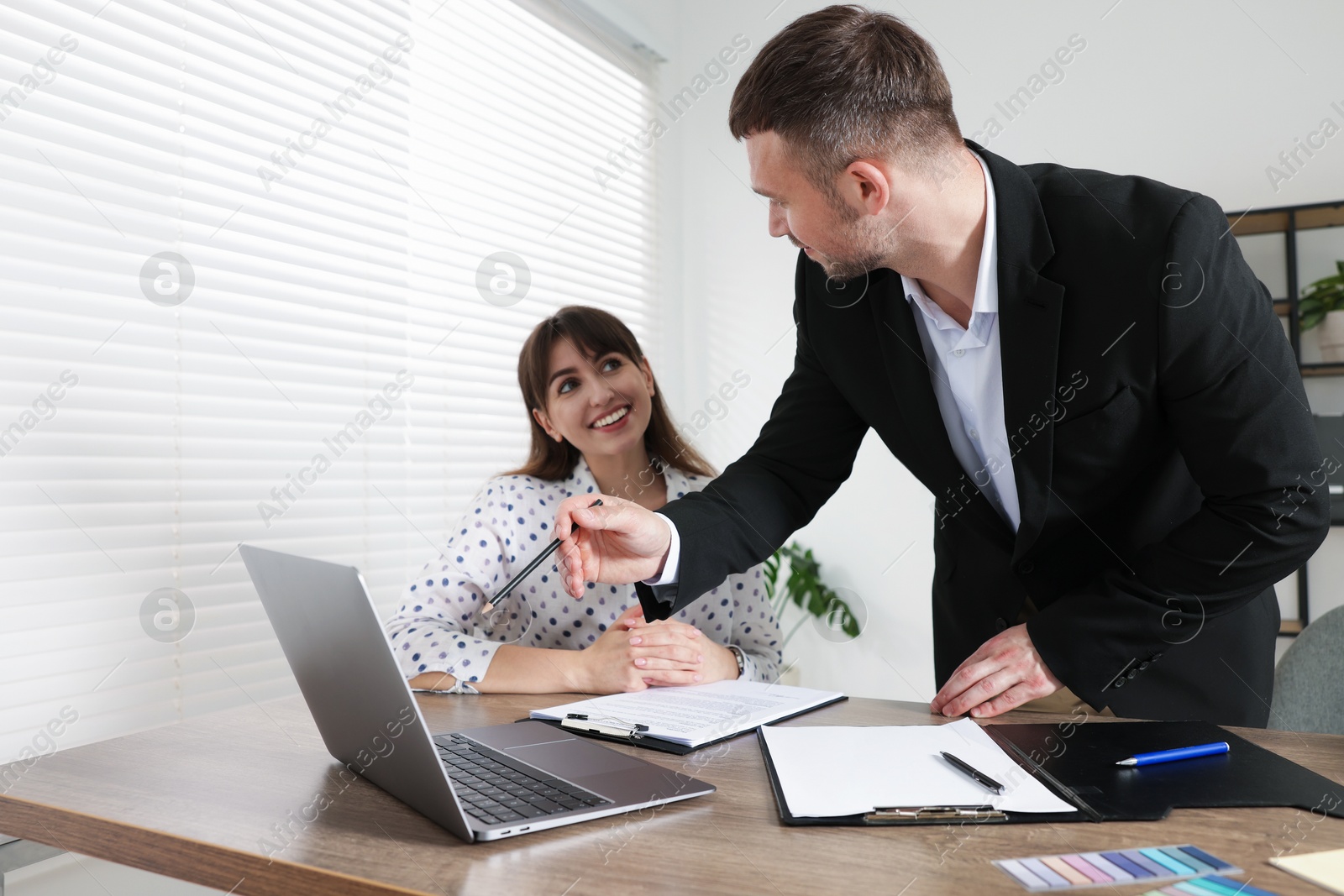 Consultant working with client at table in office. Business meeting Photo of Consultant working with client at table in office. Business meeting