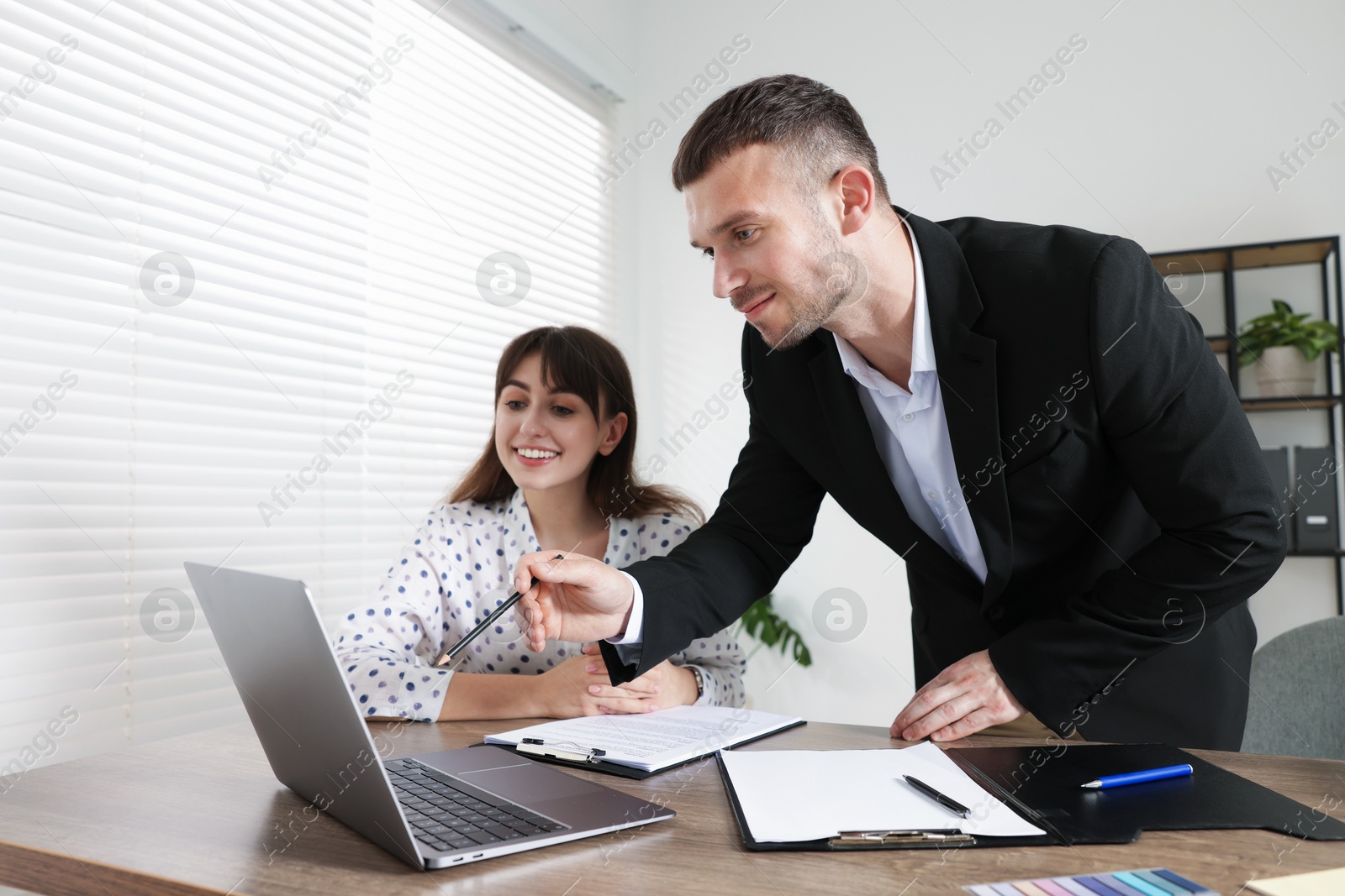 Consultant working with client at table in office. Business meeting Photo of Consultant working with client at table in office. Business meeting