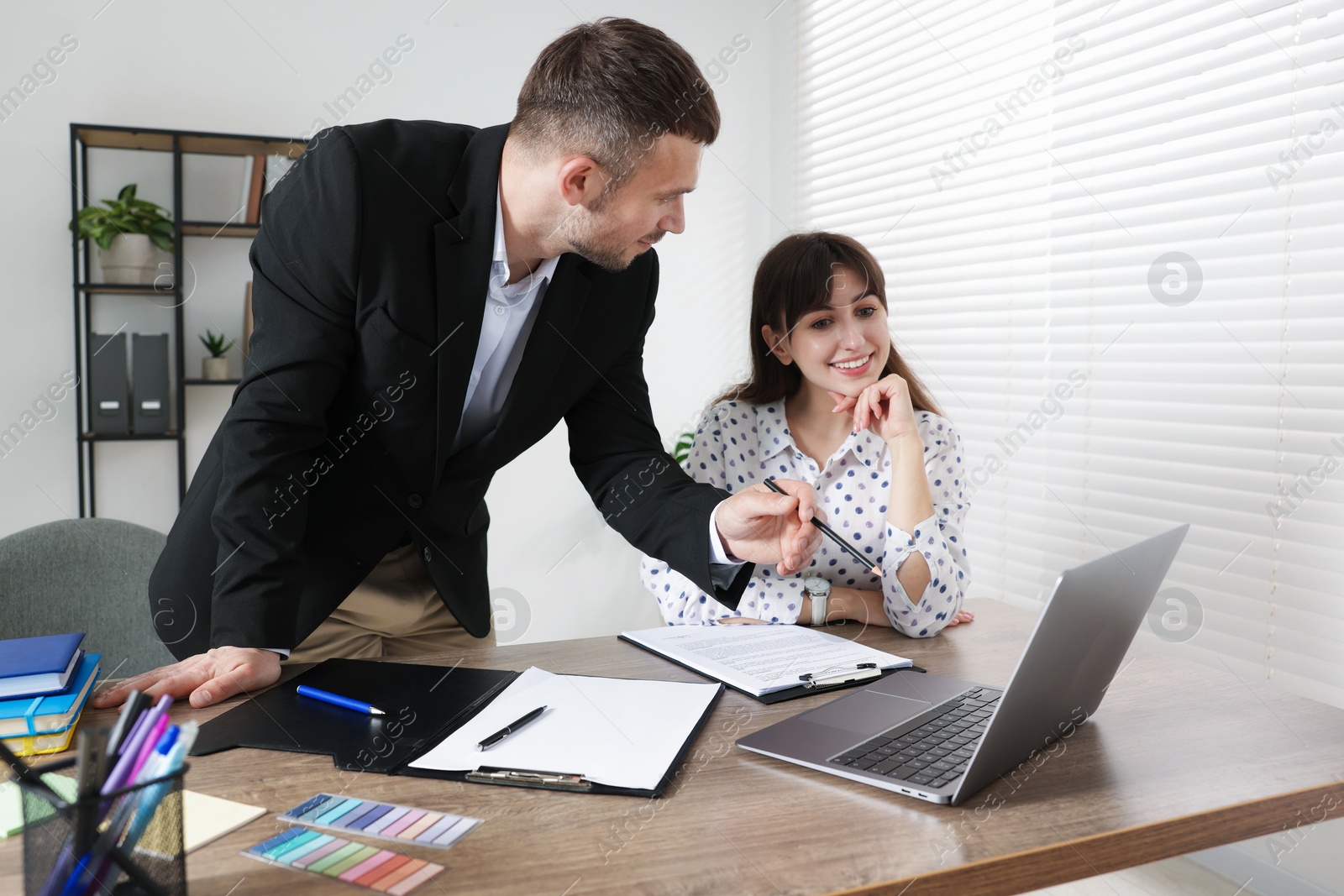 Consultant working with client at table in office. Business meeting Photo of Consultant working with client at table in office. Business meeting