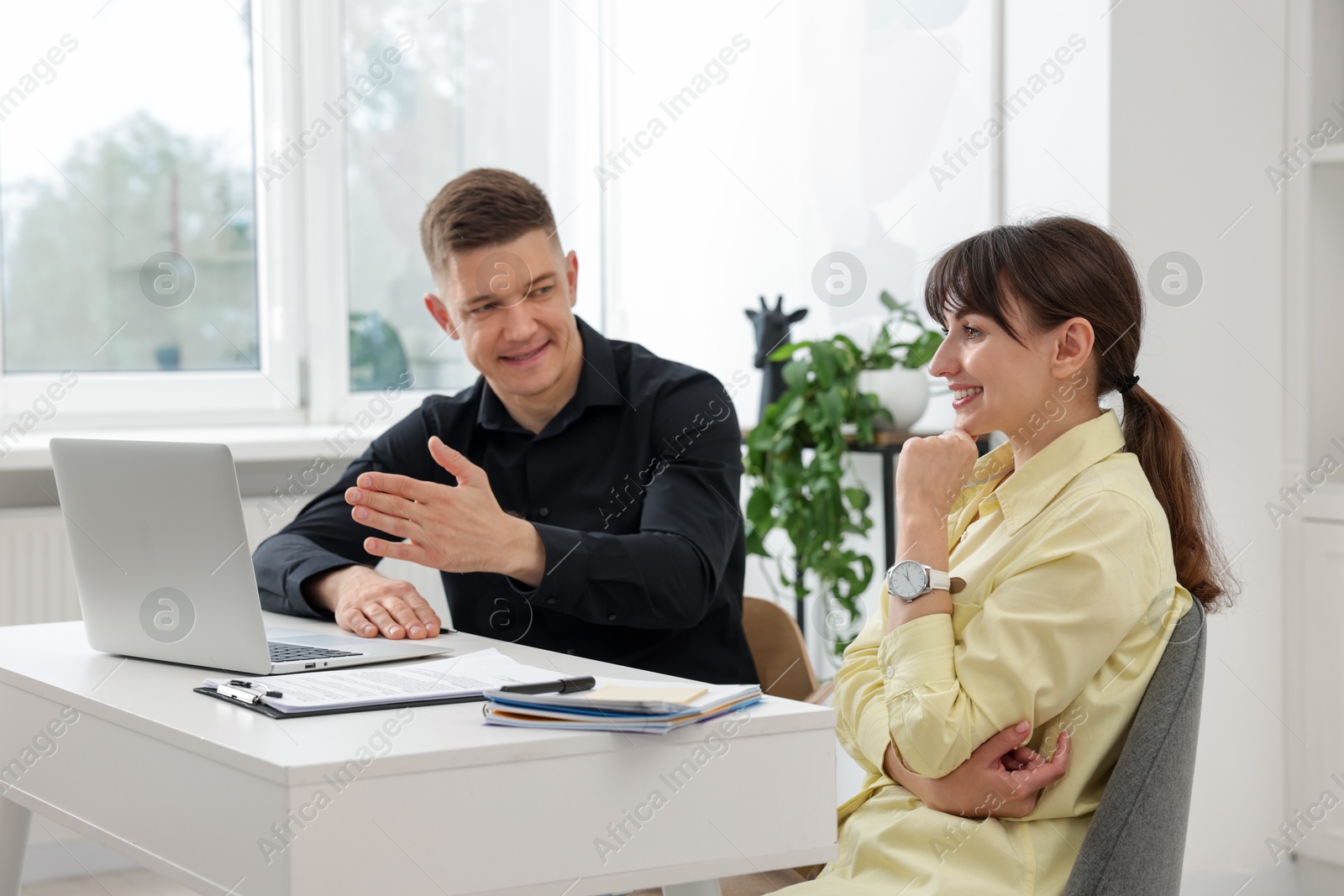 Consultant working with client at table in office. Business meeting Photo of Consultant working with client at table in office. Business meeting