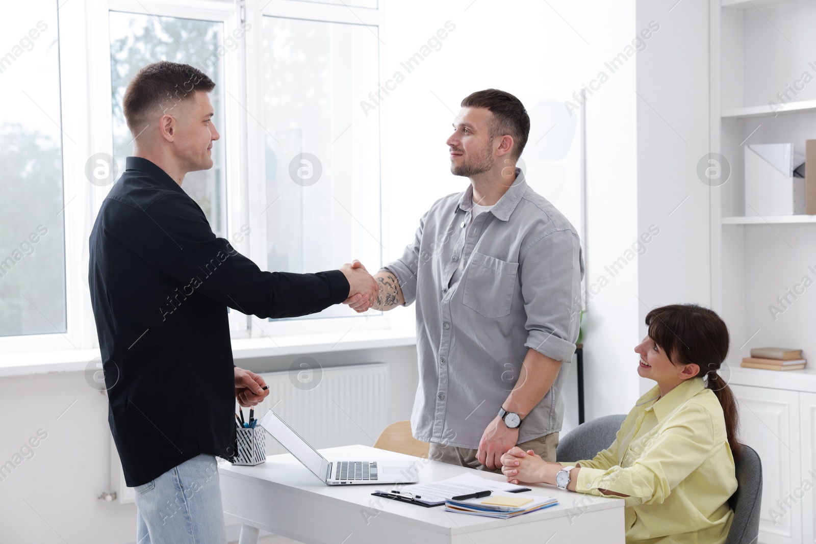 Couple having meeting with business consultant in office Photo of Couple having meeting with business consultant in office