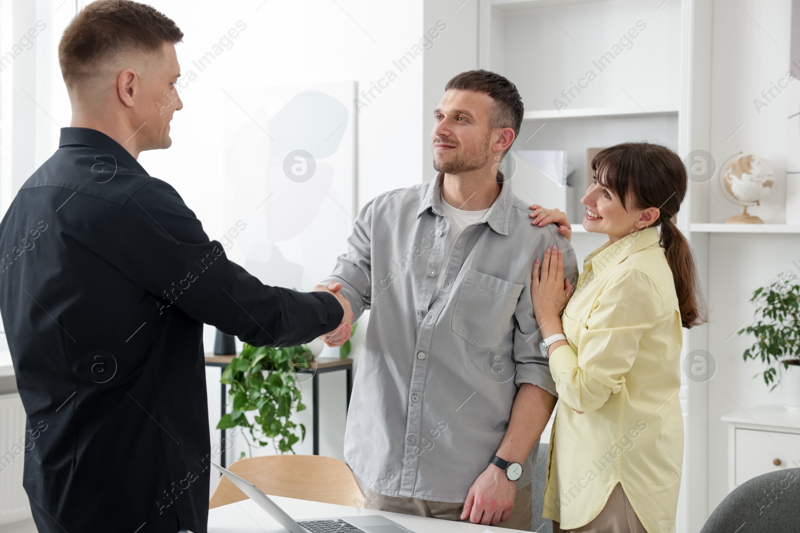Couple having meeting with business consultant in office Photo of Couple having meeting with business consultant in office